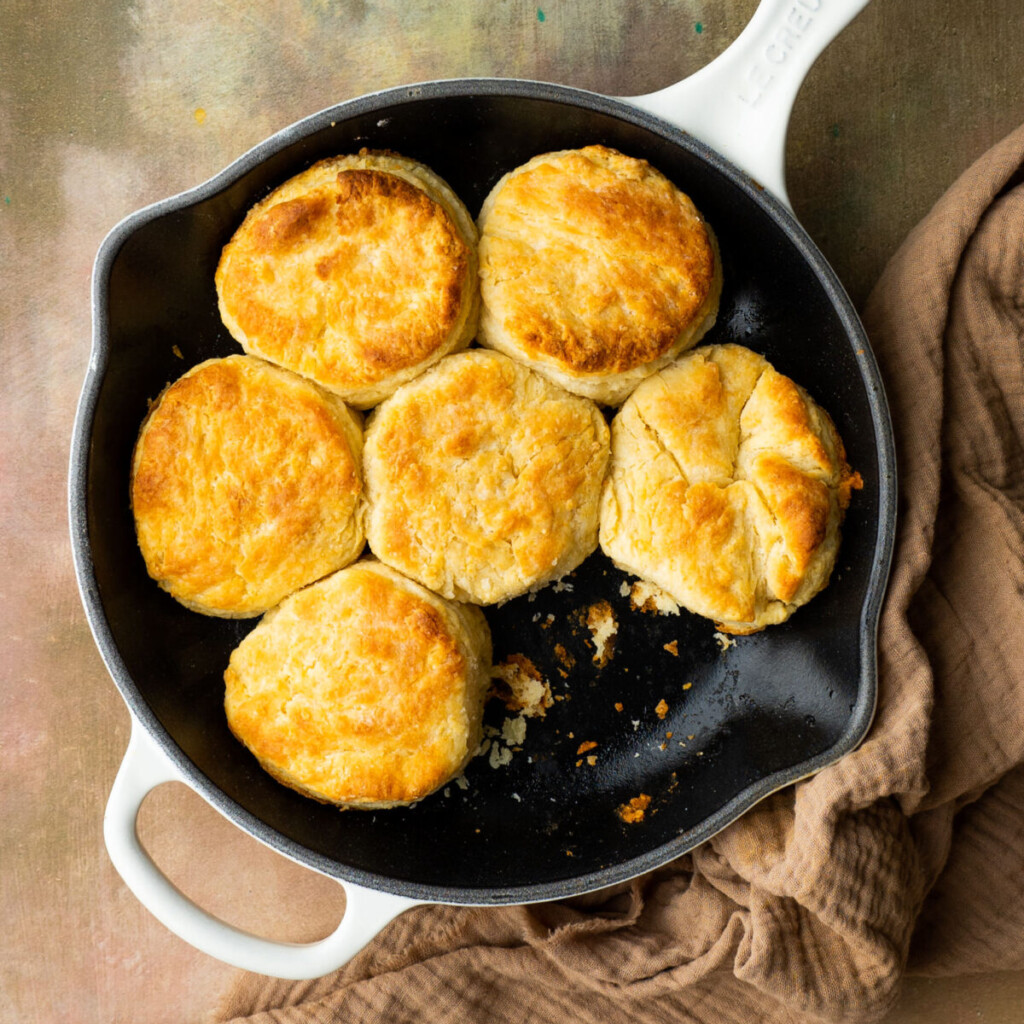 an above view image of flaky butter biscuits in a cast iron skillet