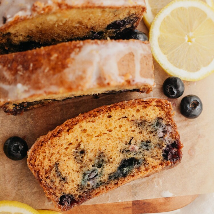 an above view photo of slices of lemon blueberry bread on a pice of wax paper