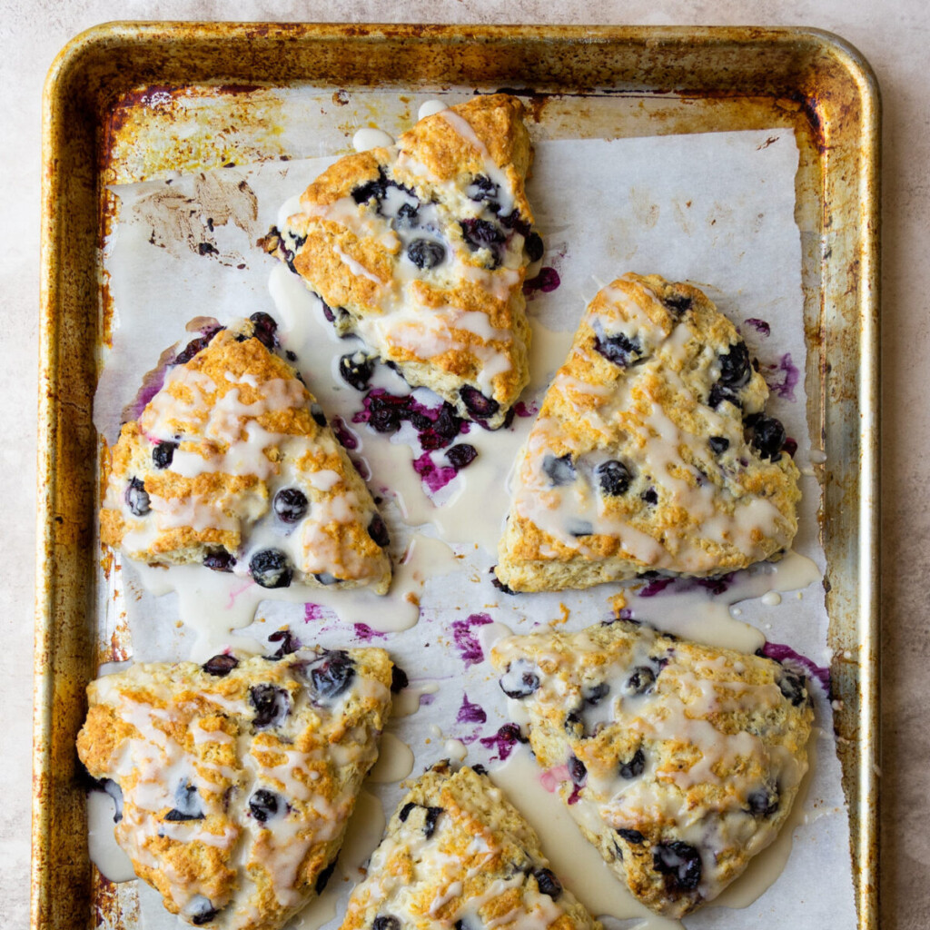 an above view image of lemon blueberry scones on a baking sheet
