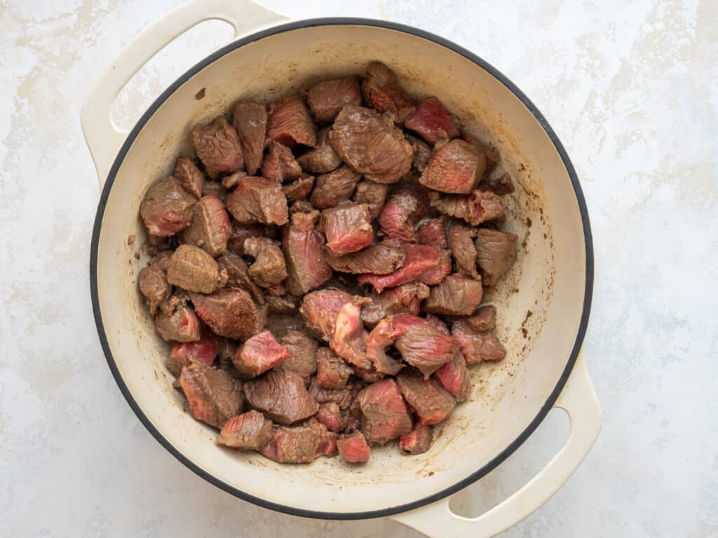 seared stew meat in a dutch oven