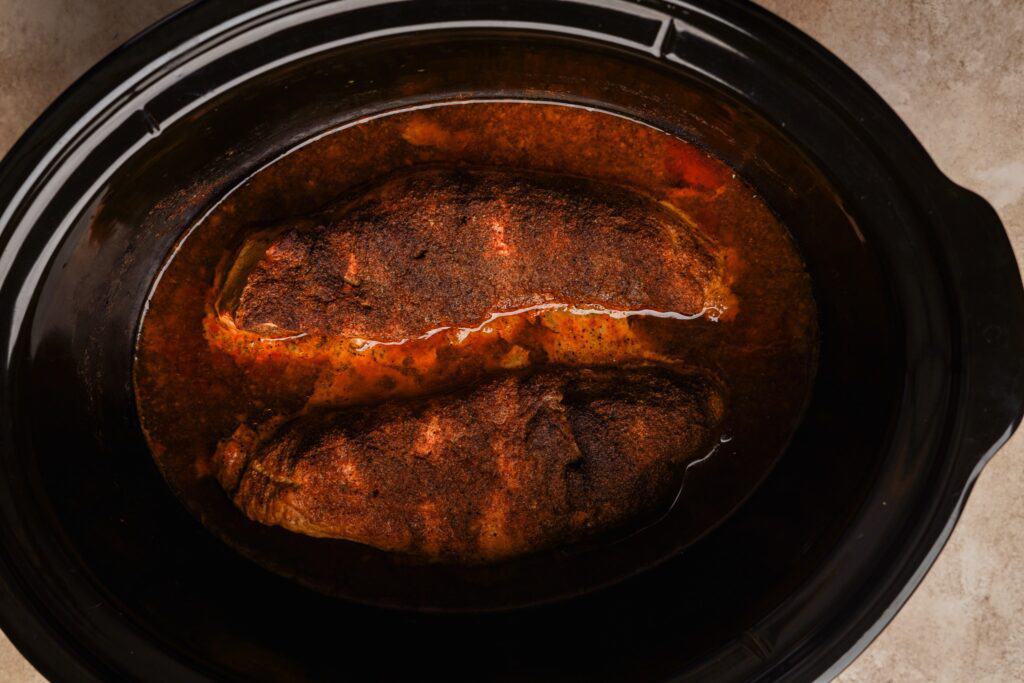 Two pork tenderloins cooked in a slow cooker