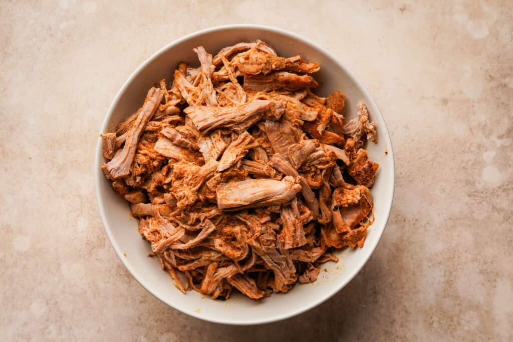 Shredded cooked pork tenderloin in a serving bowl