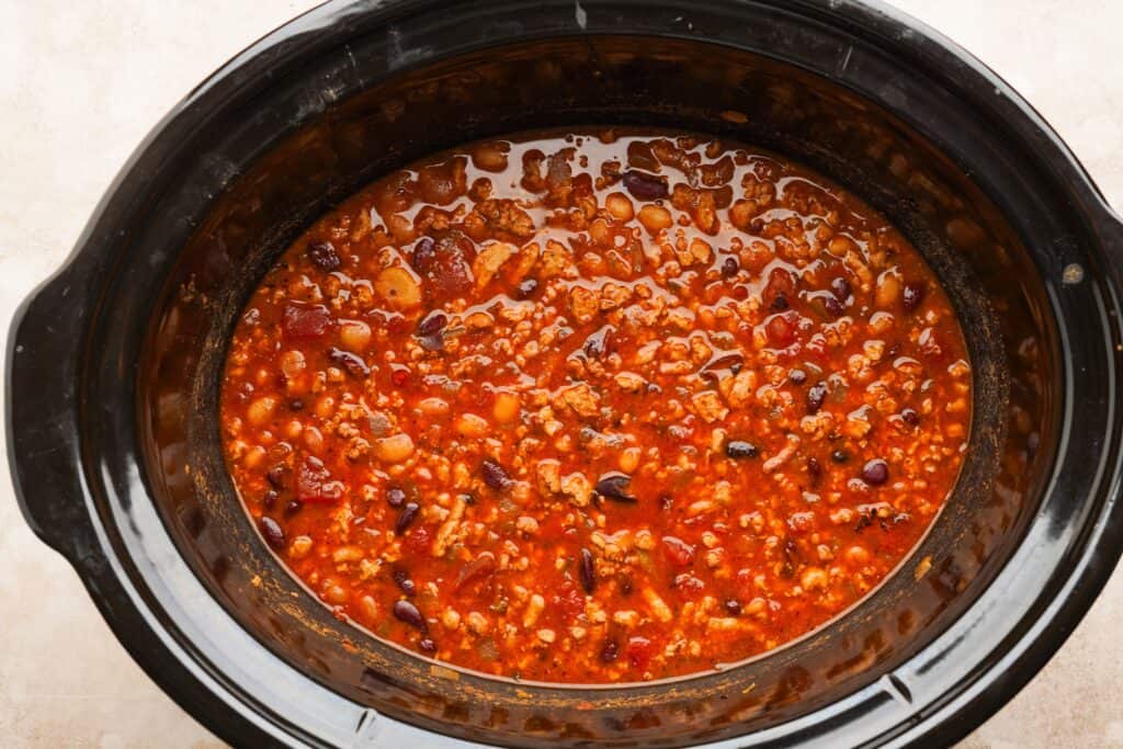 Cooked chili sitting in a slow cooker