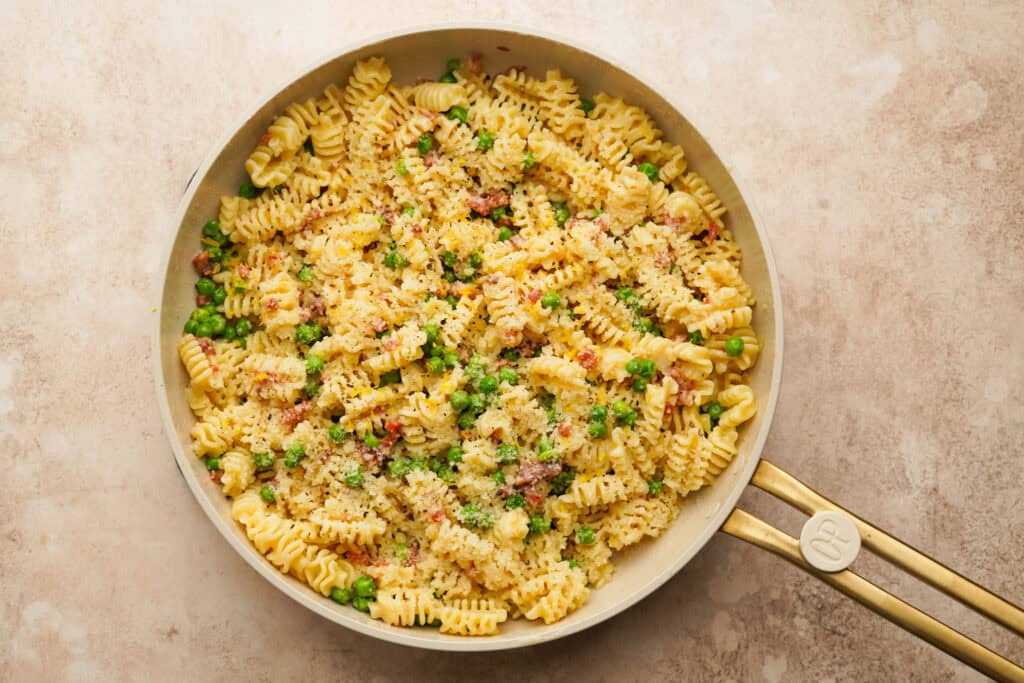 pasta with pancetta and peas in a pan
