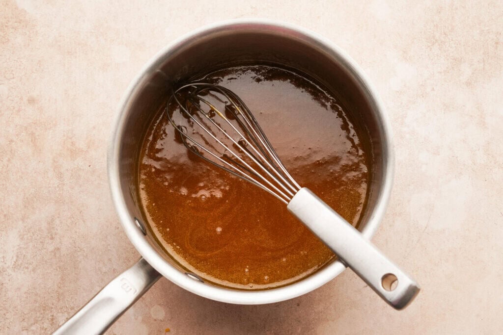 a small sauce pot with a sugar sauce inside made from butter, brown sugar and worcestershire sauce