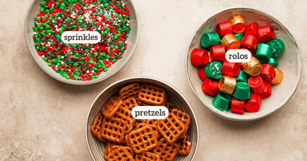 Ingredients for rolo pretzel bites: waffle shaped pretzels, rolo candies in their wrappers, and red and green christmas sprinkles