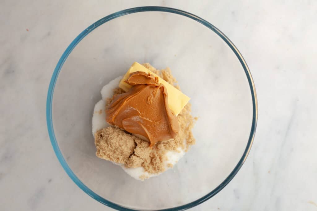 peanut butter, butter, sugar, and brown sugar in a mixing bowl 