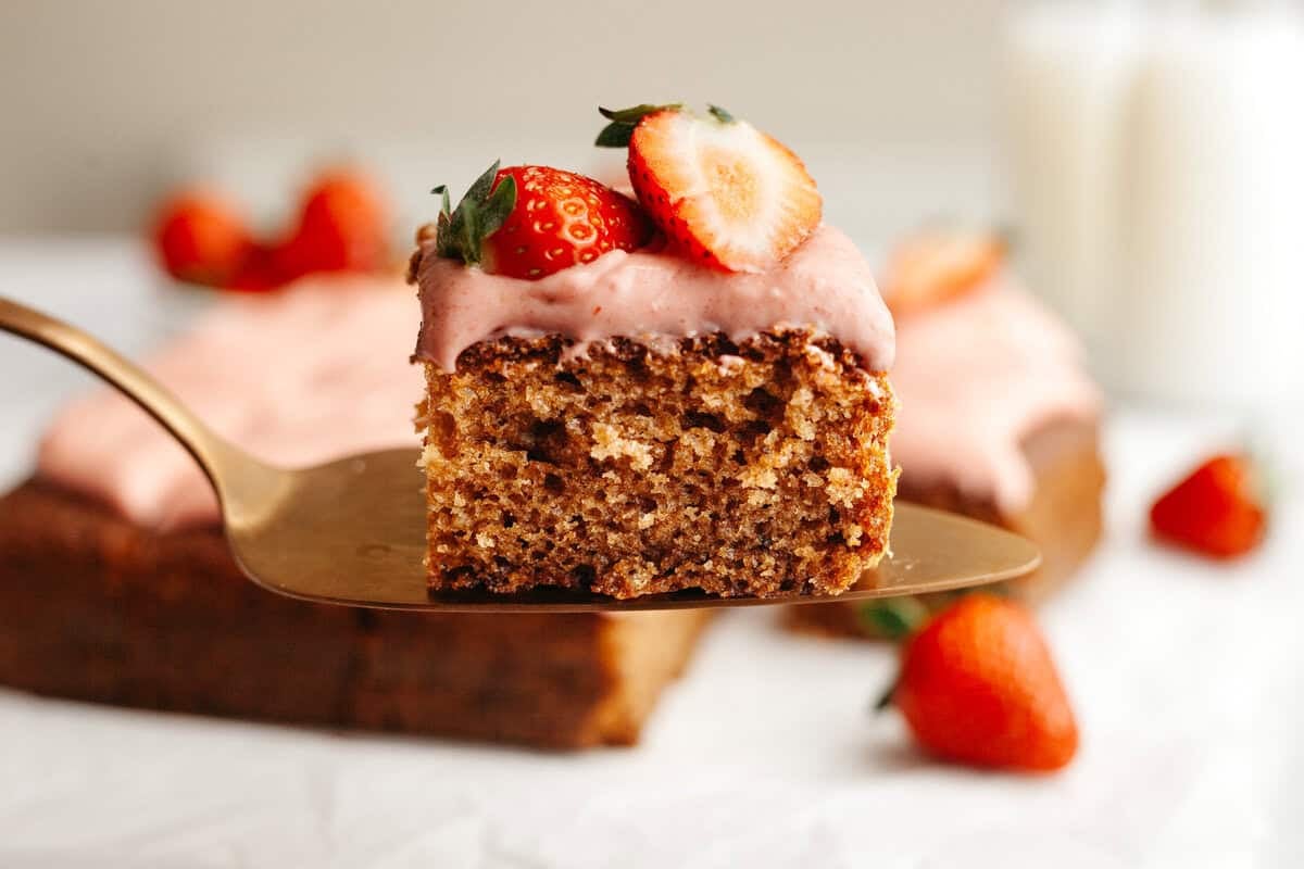 a piece of strawberry snack cake held up on a serving knife
