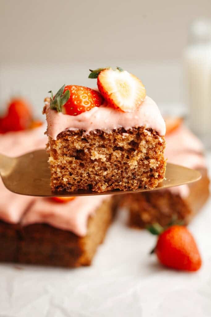 a piece of strawberry snack cake held up on a serving knife
