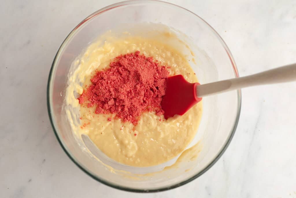 cake batter mixture with freeze dried strawberry powder on top