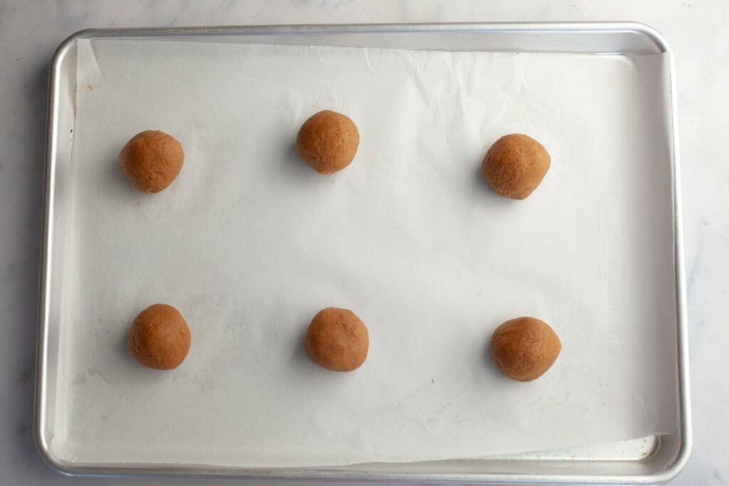 scoops of cookie dough on a baking sheet