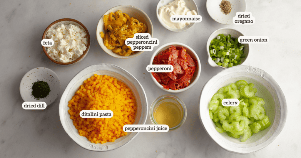 Ingredients for pepperoni and pepperoncini pasta salad with a label on each ingredient