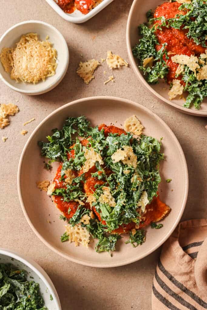 buffalo chicken cutlet on a plate with kale slaw