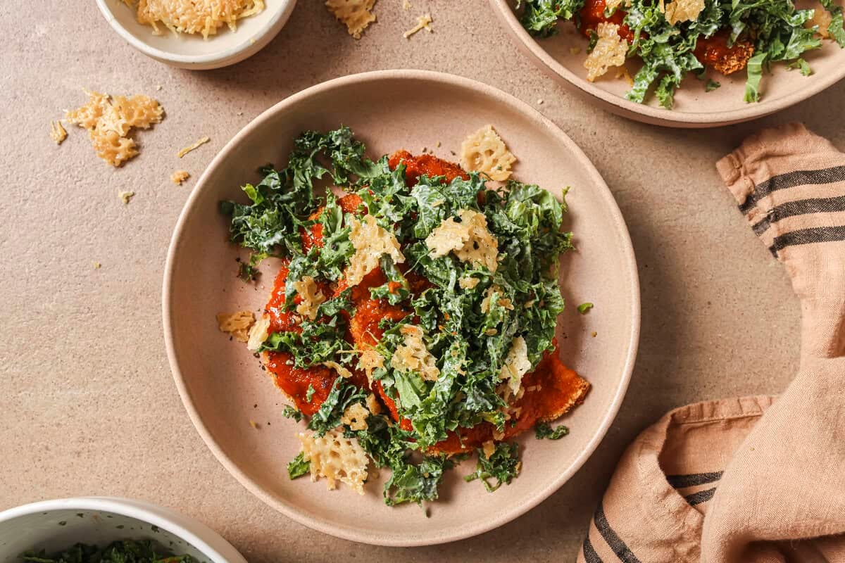 buffalo chicken cutlet with kale slaw on a ceramic plate