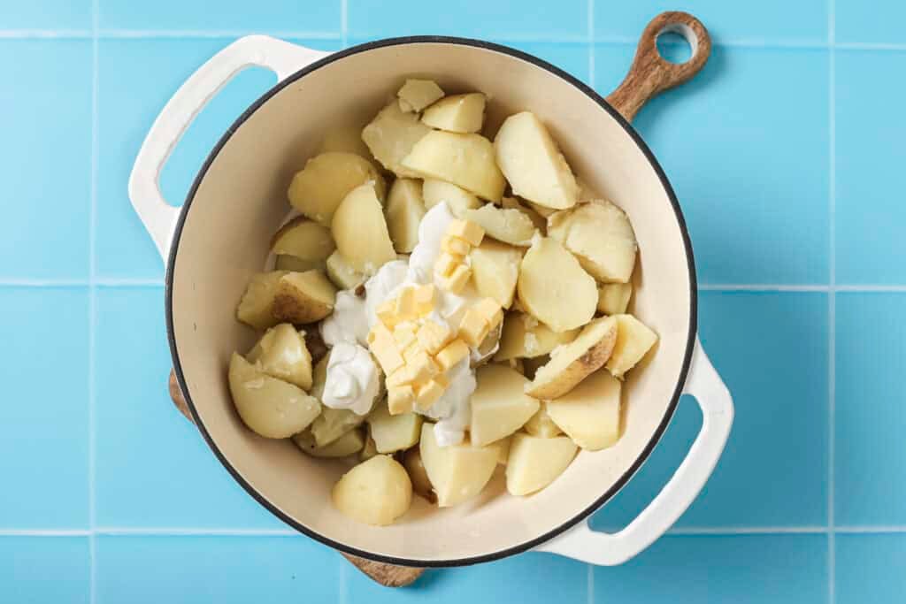 all greek yogurt mashed potato ingredients in pot before mashing