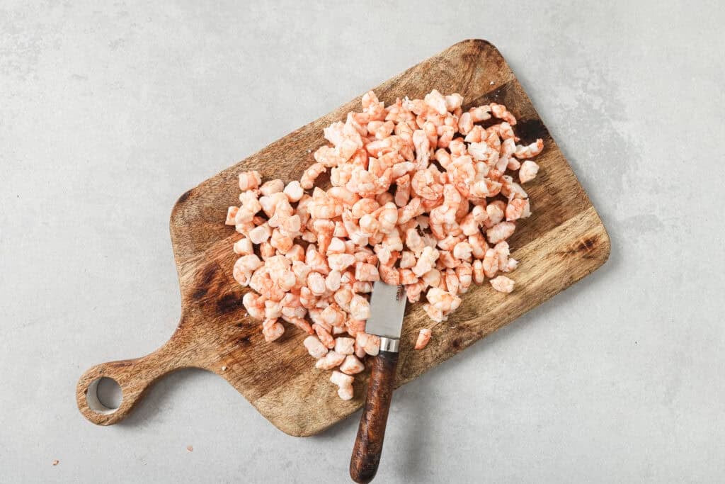 shrimp diced on cutting board