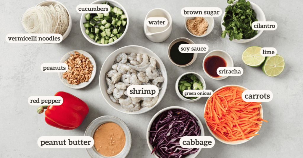 spring roll salad ingredients in ceramic bowls and plates