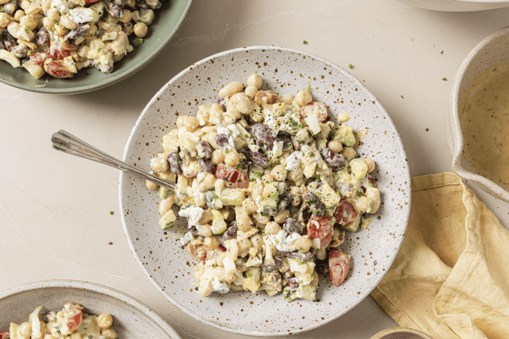 3 bean cobb salad on a plate with a spoon in it