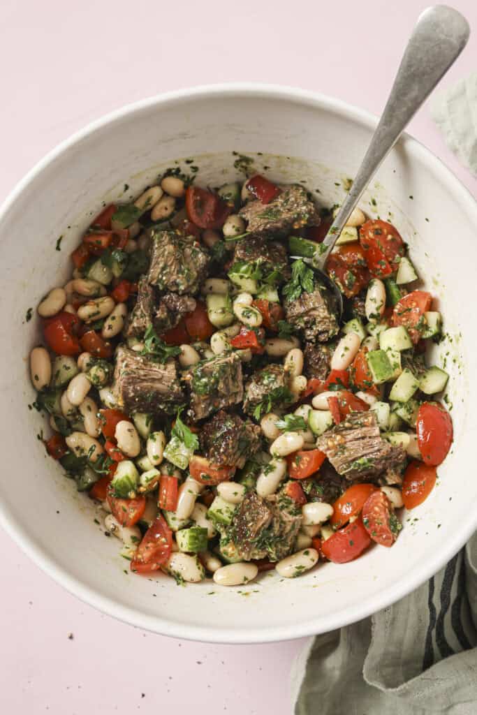final dish of chimichurri steak salad in a bowl with a spoon