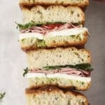 A summer focaccia sandwich cut into slices lined up next to each other