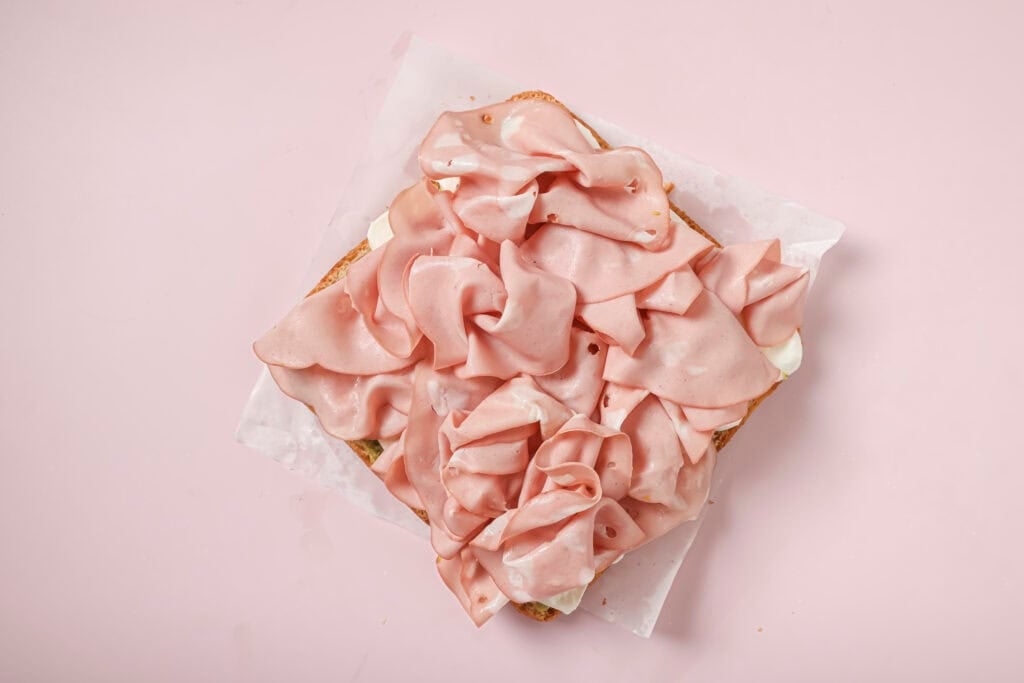focaccia sandwich with pieces of mortadella on top