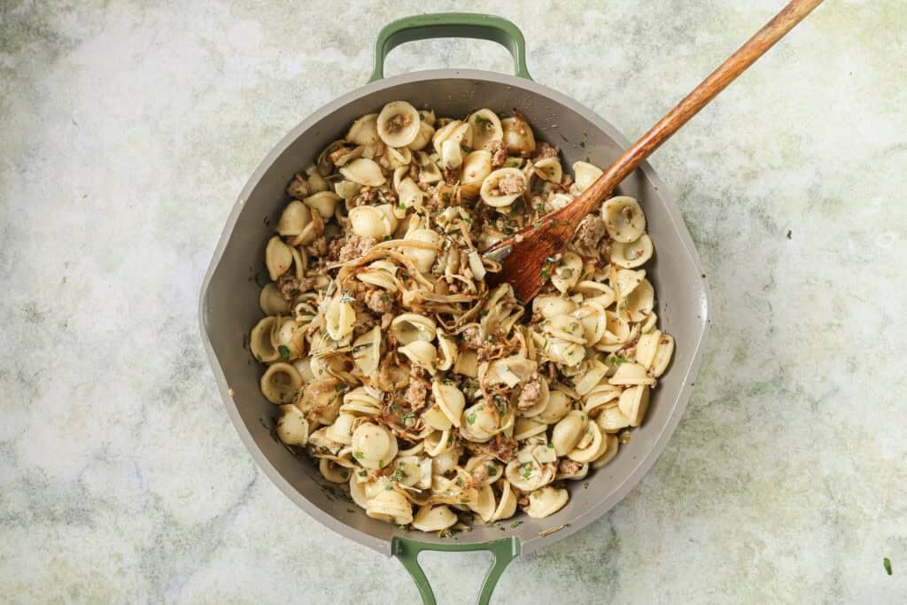 final sausage fennel pasta dish being mixed together