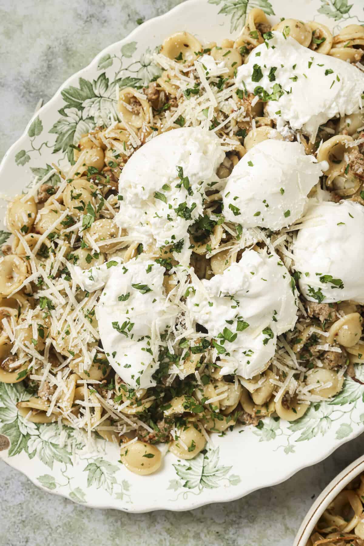 plated dish of sausage fennel pasta with burrata cheese on top