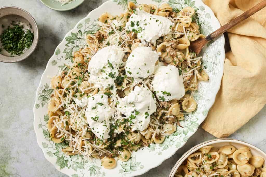 a final dish of sausage fennel pasta with burrata on top