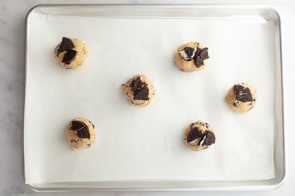 peanut butter oreo cookie balls on a baking sheet