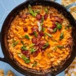 a skillet with bacon cheddar jalapeno corn dip in it