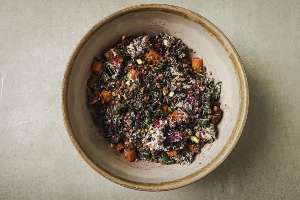 roasted beet and lentil chopped salad in a tan bowl